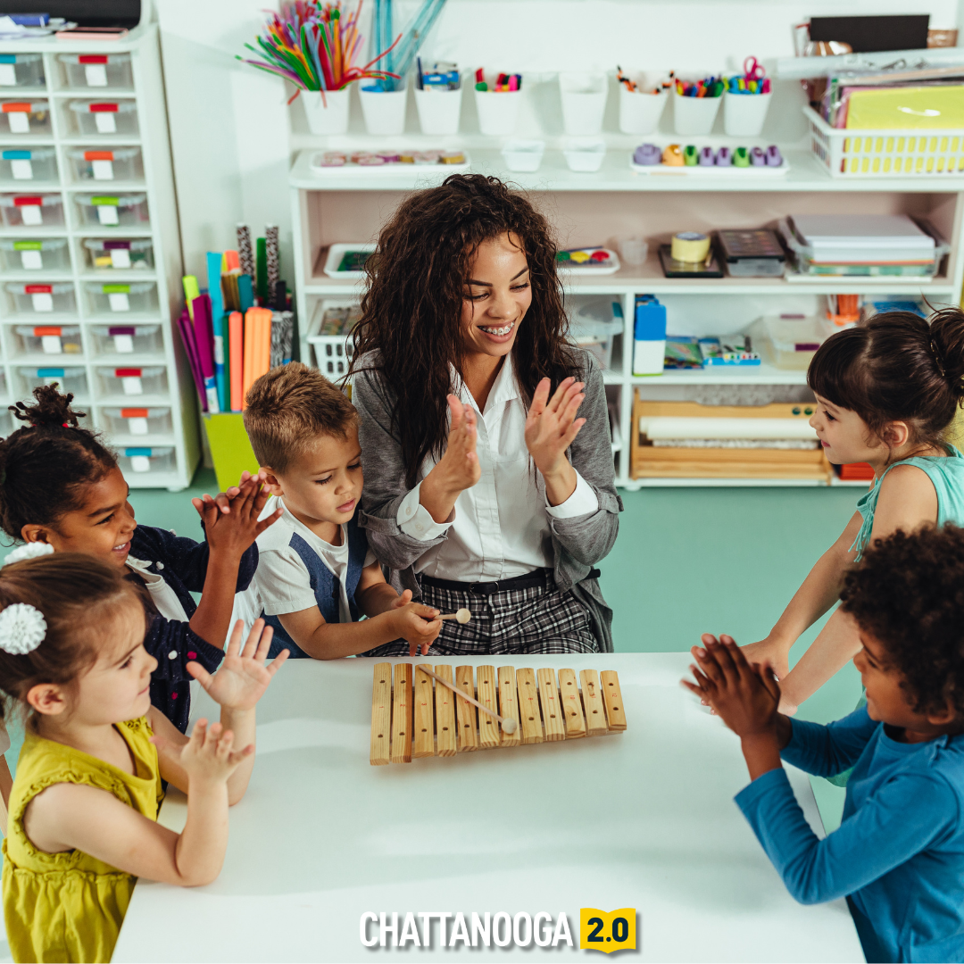 A child care teacher and her students play with a xylophone.