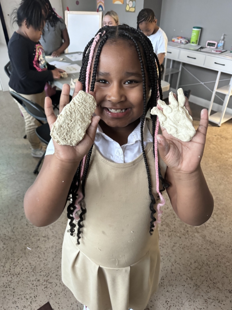 A student enrolled in a Girls Inc. of Chattanooga afterschool program displays a product she created after completing an activity included in the OST K-2 Literacy Toolkit in spring 2024